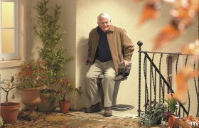 a man riding one of many Used Stair Lifts in South Jersey, Philadelphia, Mt. Laurel, Wilmington, Princeton, King of Prussia